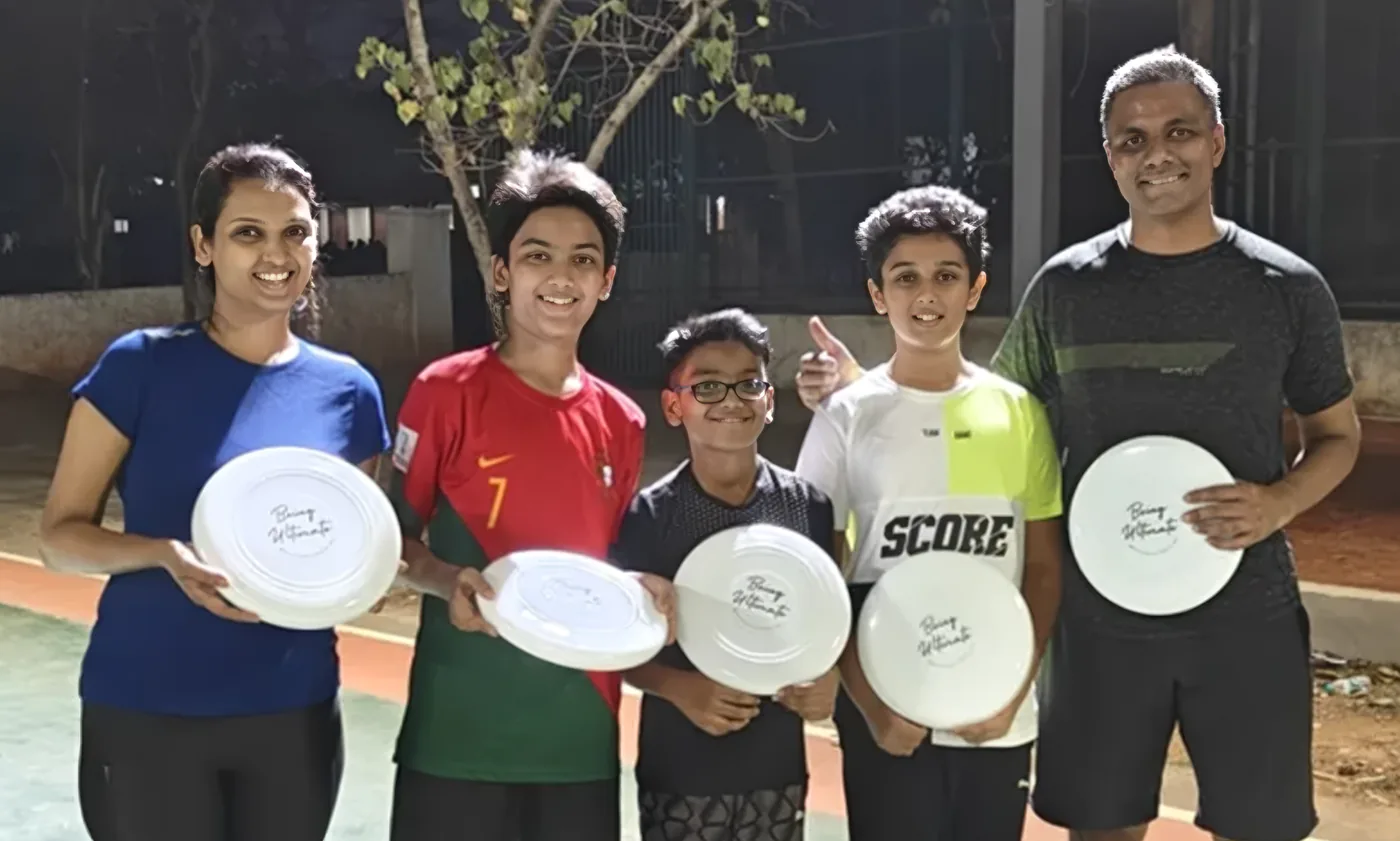 A family holding Being Ultimate discs after a Famtivity session